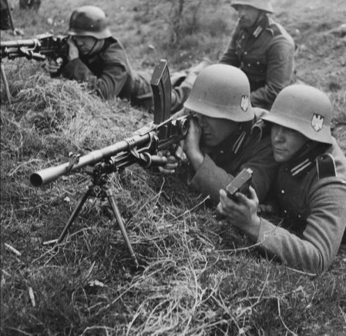 Note the use of British weapons. Here they are shown using a BREN gun.
