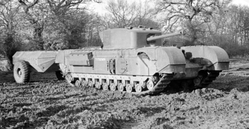 The use of the tank mounted “Oke” flamethrower by the Calgary Regiment at Dieppe, although rudimentary in nature, led to development of a more advanced model, of a tank-mounted flamethrower, again based on the Churchill chassis, which came to be known as the Churchill Crocodile, seen pictured here. The flame projector on the Crocodile, replaced the hull mounted machine gun, and had a range of 80 to 120 yards. The armoured fuel trailer, held 400 gallons of flame fuel and enough compressed nitrogen propellant for 80 one second bursts of flame through the flame projector. This trailer was connected to the tank by a three-way armoured coupling and could be jettisoned from within the tank if necessary. Source: Authors’ collection.