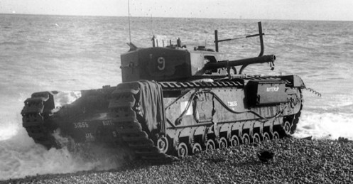 T31655 Buttercup, a Churchill Mk III of No. 9 Troop “B” Squadron, The Calgary Regiment, commanded by Sergeant J.D. Morrison, also one of five Churchill tanks of the regiment that was fitted with the “Beach Track Laying Device,” for the Dieppe raid. Having successfully landed and laid its chespaling and, having crossed the beach, wire, and seawall, it successfully jettisoned its beach track laying device, whereupon it engaged enemy targets on the west headland and in seafront buildings to the west of the Casino. Later, it returned to the beach below the Casino, where it took up a position on the water’s edge. It could not be destroyed by its crew prior to their withdrawal, due to the number of infantry wounded who had sought shelter from enemy fire on its seaward side. Note that there are no remnants of the beach track laying device, on her front, it having been jettisoned successfully. Source: Authors’ collection.
