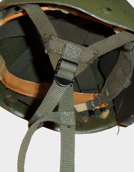 A close-up of the modified strap attachments on a Canadian-modified M1 Parachutist’s Helmet.
