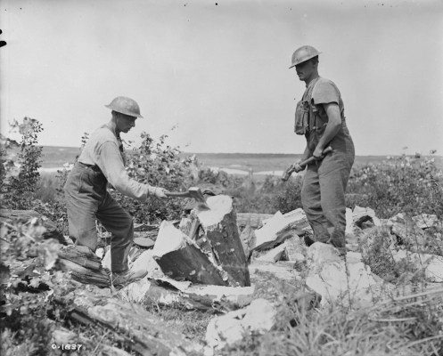 Canadian pioneers splitting logs for use in trenches. August, 1917.