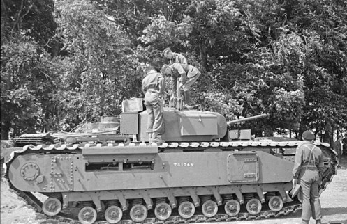 An example of the new Infantry Tank Mark IV, Churchill (A22), that came straight from the Vauxhall Motors production line, that was issued to the Ontario Regiment on 10 July 1941, being inspected by Lieutenant-General A.G.L. McNaughton (hatless) and Brigadier F.F. Worthington (standing on the upper track run, with his back to the camera). Source: authors’ collection.