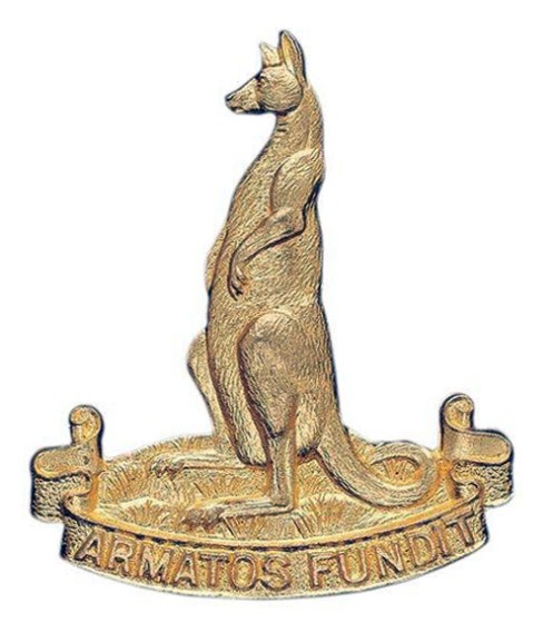 The approved badge. The unit title was replaced with the unit's Latin motto which translates as 'It pours forth armed men".