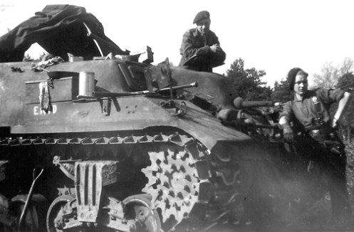 ENID, a Kangaroo of the 1st Canadian Armoured Personnel Carrier Regiment, showing a closer view of examples of the crescent shaped ‘tarp/bivouac’ supports, the secondary .30-calibre Browning machine gun (with the feed tray) mounted in the front of the turret ring, with its barrel pointing to the right, the track extended end connectors on the outside edge of the track, and the later style of bogie assembly, with the return roller mounted on a trailing arm behind the bogie assembly. Source: 1 CACR Association & Archive