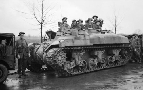 A ‘Ram’ Kangaroo armoured personnel carrier of “A” Squadron, 49th Armoured Personnel Carrier Regiment, carrying infantrymen of the 4th Battalion, Dorsetshire Regiment, 130th British Infantry Brigade, on the outskirts of Ochtrup, Germany, 3 April 1945, prior to the liberation of Enschede, Holland. Source: Imperial War Museum (BU 2956)