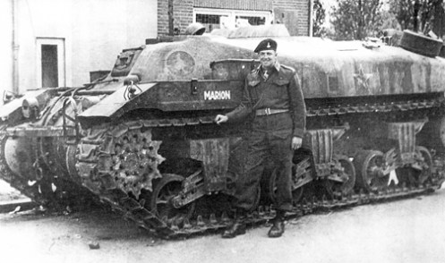 One of the ‘Ram’ armoured ammunition carriers issued to 1st Canadian Armoured Personnel Carrier Regiment, as a ‘command’ carrier, bearing the name MARION (CT159891), seen here, in June 1945, as the ‘Kangaroo’ of Major W.A. Copley, Officer Commanding, “B” Squadron, which he named after his wife Marion. Just above Major Copley’s head, on the top of the hull, can be seen, the 7-inch (18-centimetre) high, splash plate, which was installed around the 28-inch (71-centimetre) square double hinged hatches, in the centre of the circular armoured plate that was placed over the turret ring, as described in the text. Source: Bill Miller