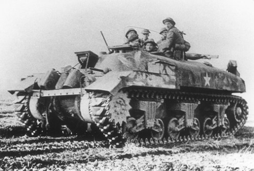 A ‘Ram’ Kangaroo armoured personnel carrier of “A” Squadron, 1st Canadian Armoured Personnel Carrier Regiment, lifting infantrymen of the Royal Winnipeg Rifles, 7th Canadian Infantry Brigade, in a thrust along the Cleve to Calcar road (Germany), on 16 February 1945, during Operation VERITABLE. Note the forward facing secondary .30-calibre Browning machine gun mounted in the turret ring, with its barrel pointing skyward. Source: MilArt photo archives