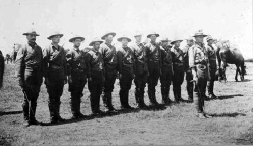 Lieutenant Lionel F. Page and members of his troop of the Red Deer Independent Squadron of the 15th Canadian Light Horse on manoeuvres at Sarcee Camp near Calgary, Alberta. Lance Corporal Caswell is 11th from left. Inscribed in pencil on verso: "Page's troop". Circa 1910